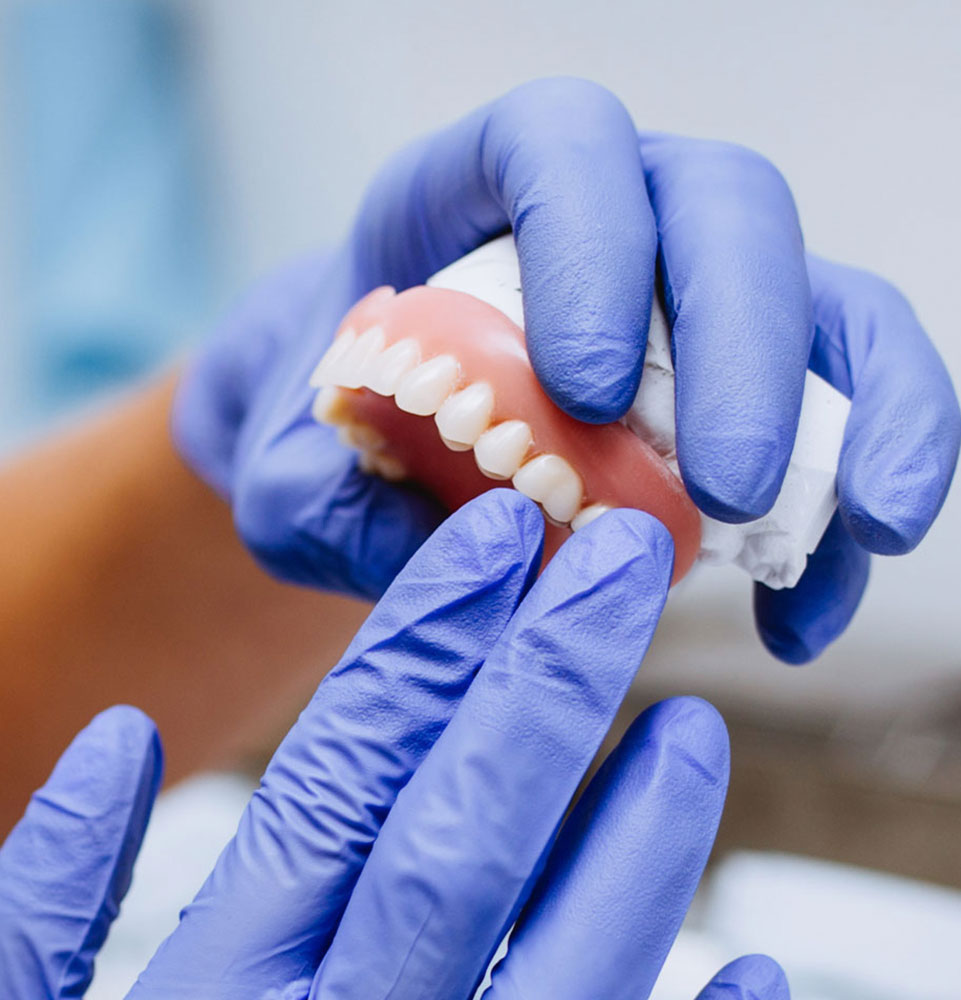 denture or full arch being held hero mobile