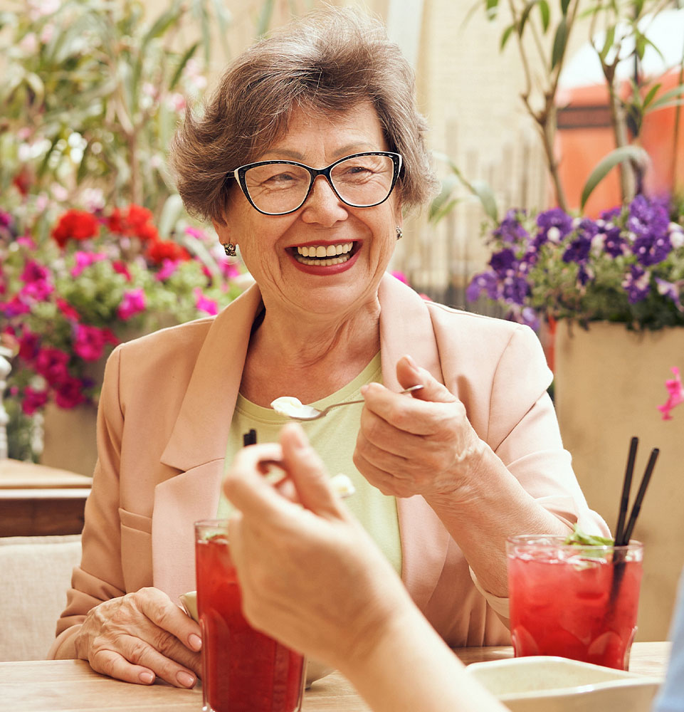 person with new teeth eating well