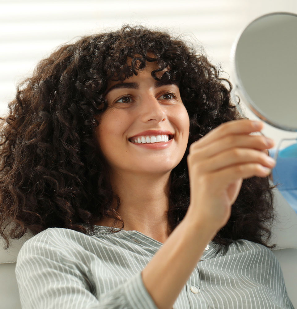 lady with curly hair pretty new smile
