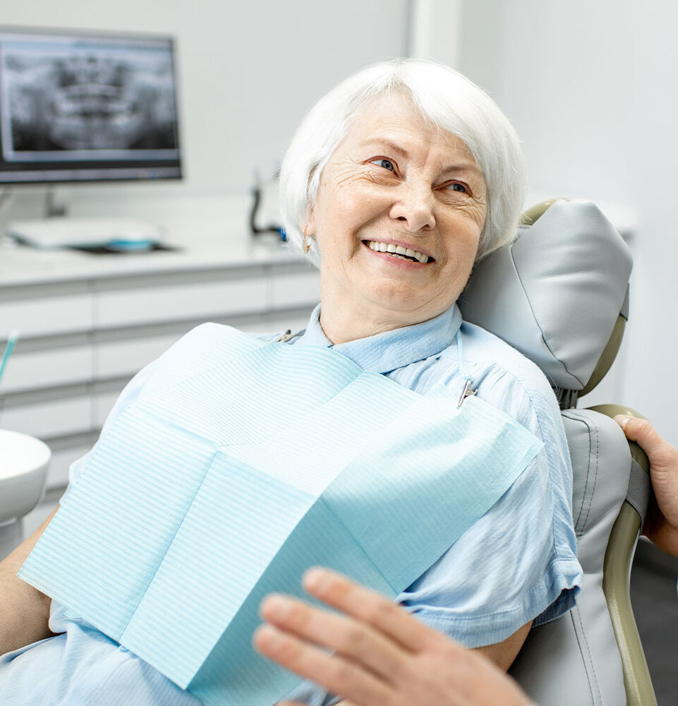 lady smiling after full arch dental implants