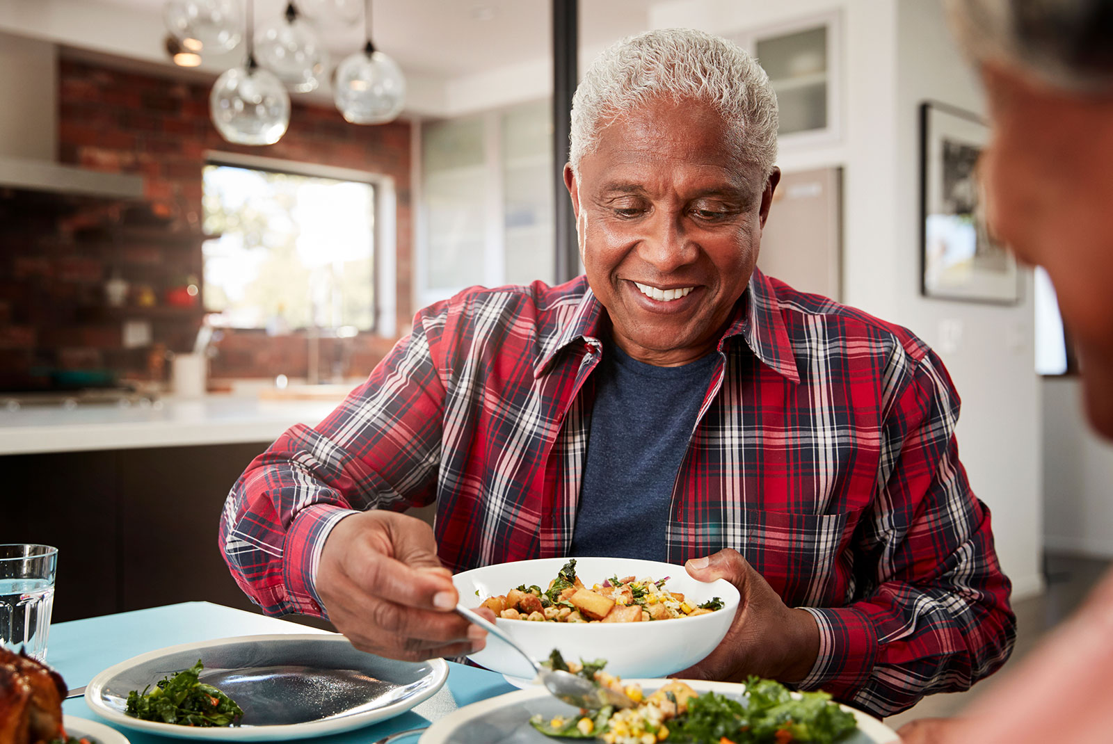 man eating with his new dental implants