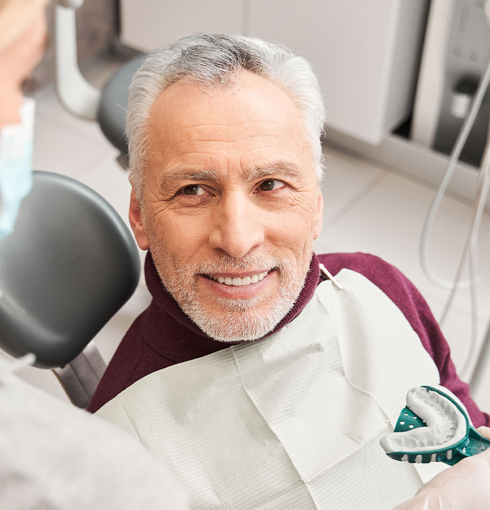 person being fitted for dentures dental implants mobile